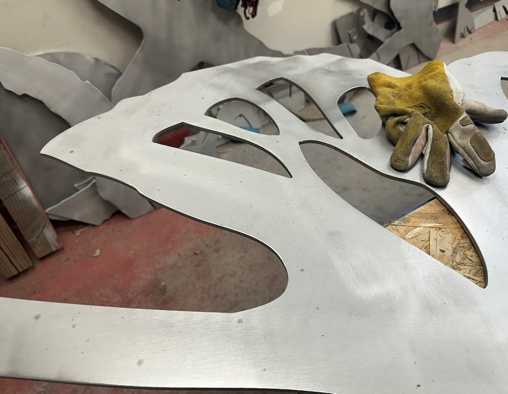 5/8/2024: We're in the cocoon phase on this project, and getting excited to see what it will become. 

The components are cut and artist Joe Norman is preparing them for welding (grinding the edges smooth, cleaning the surfaces and giving them texture to help the paint adhere, etc)